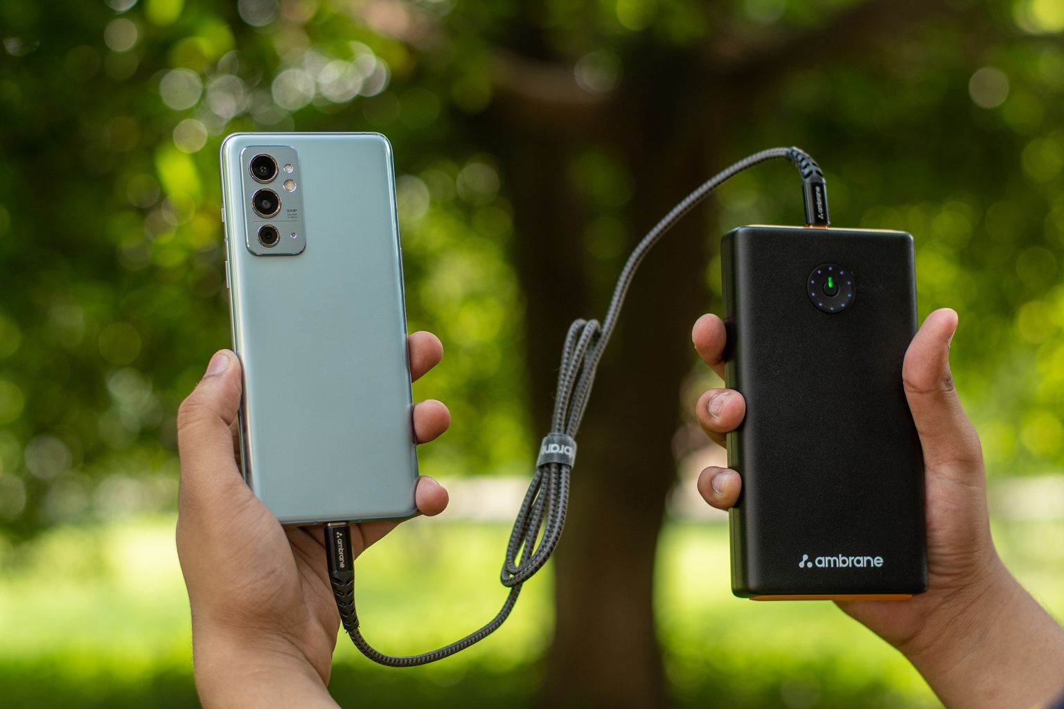 Portable charger powering a smartphone outdoors while traveling